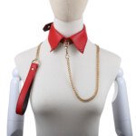 Red pointed collar with gold-colour chain lead and handle on dress form
