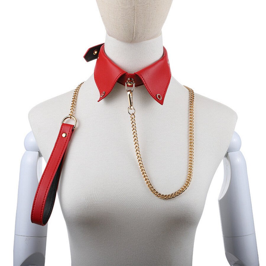 Red pointed collar with gold-colour chain lead and handle on dress form